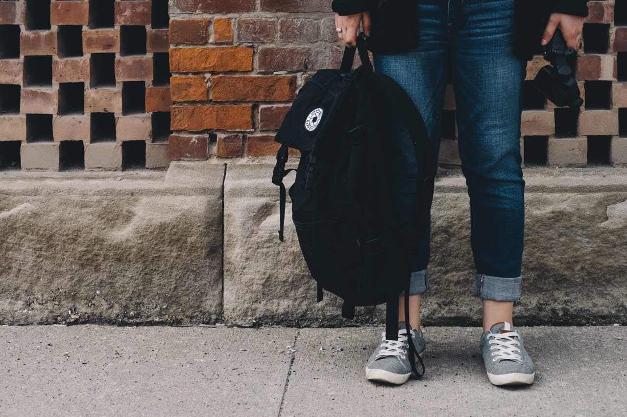 girl holding rucksack bag