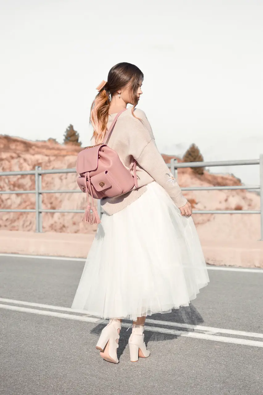 girl with pink rucksack on the road