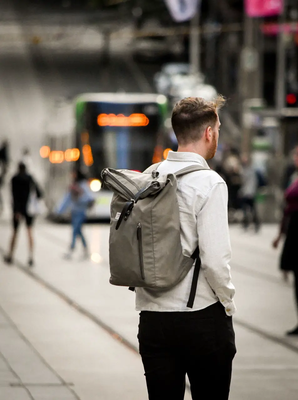 man waiting for train with rucksack backpack on