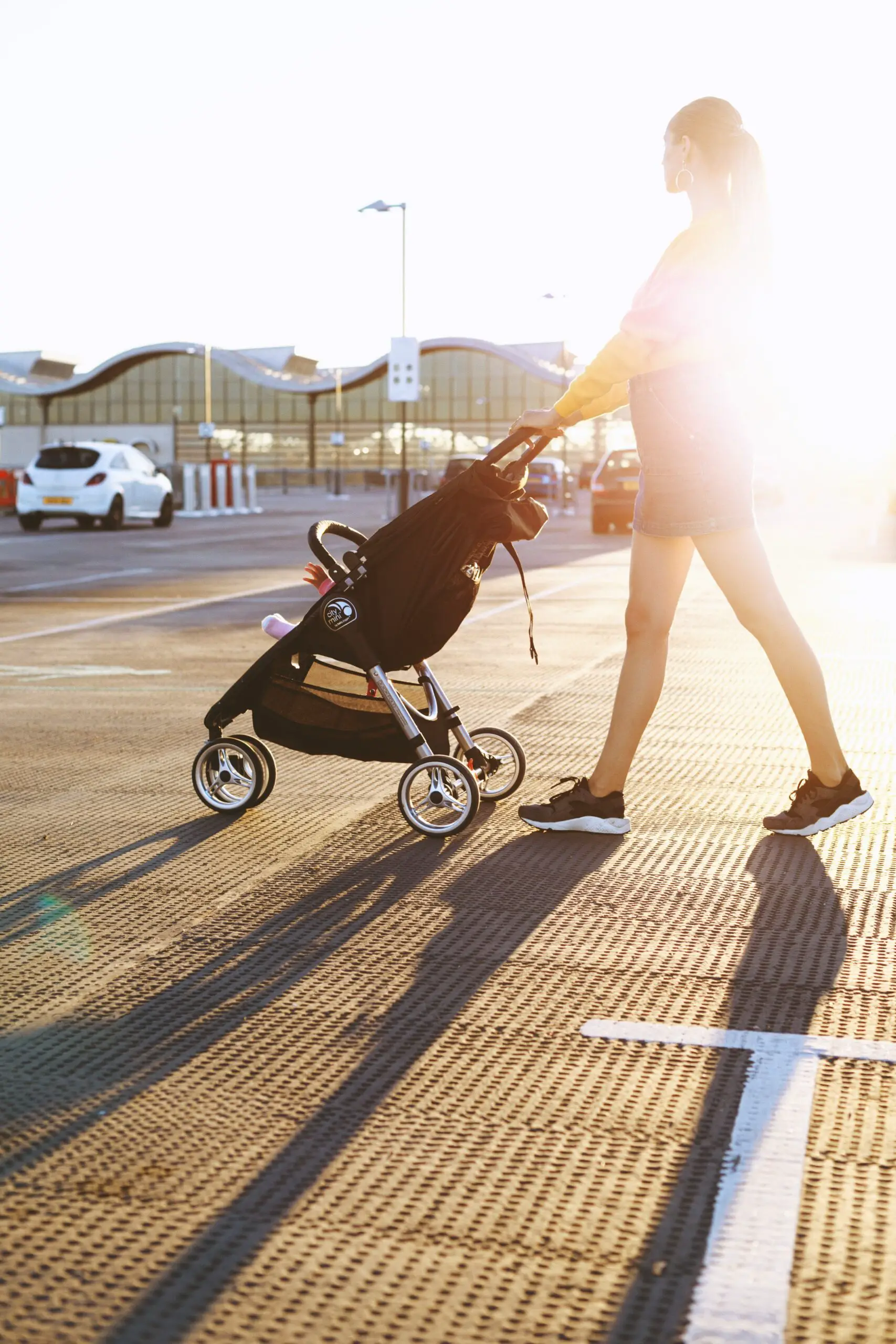 woman walking with baby in stroller at airport