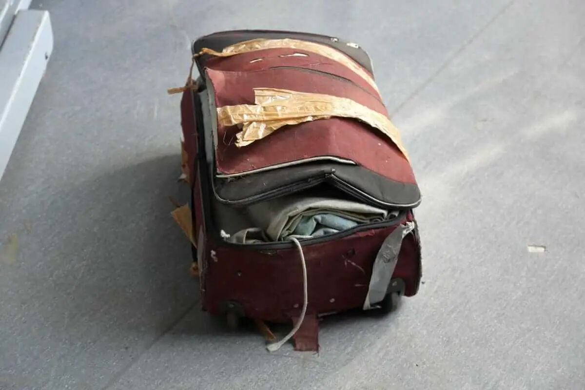 how to protect your luggage from damage - damaged luggage lying on the floor