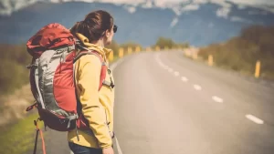 woman waiting by road with lightweight backpack