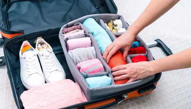properly rolling clothes into luggage