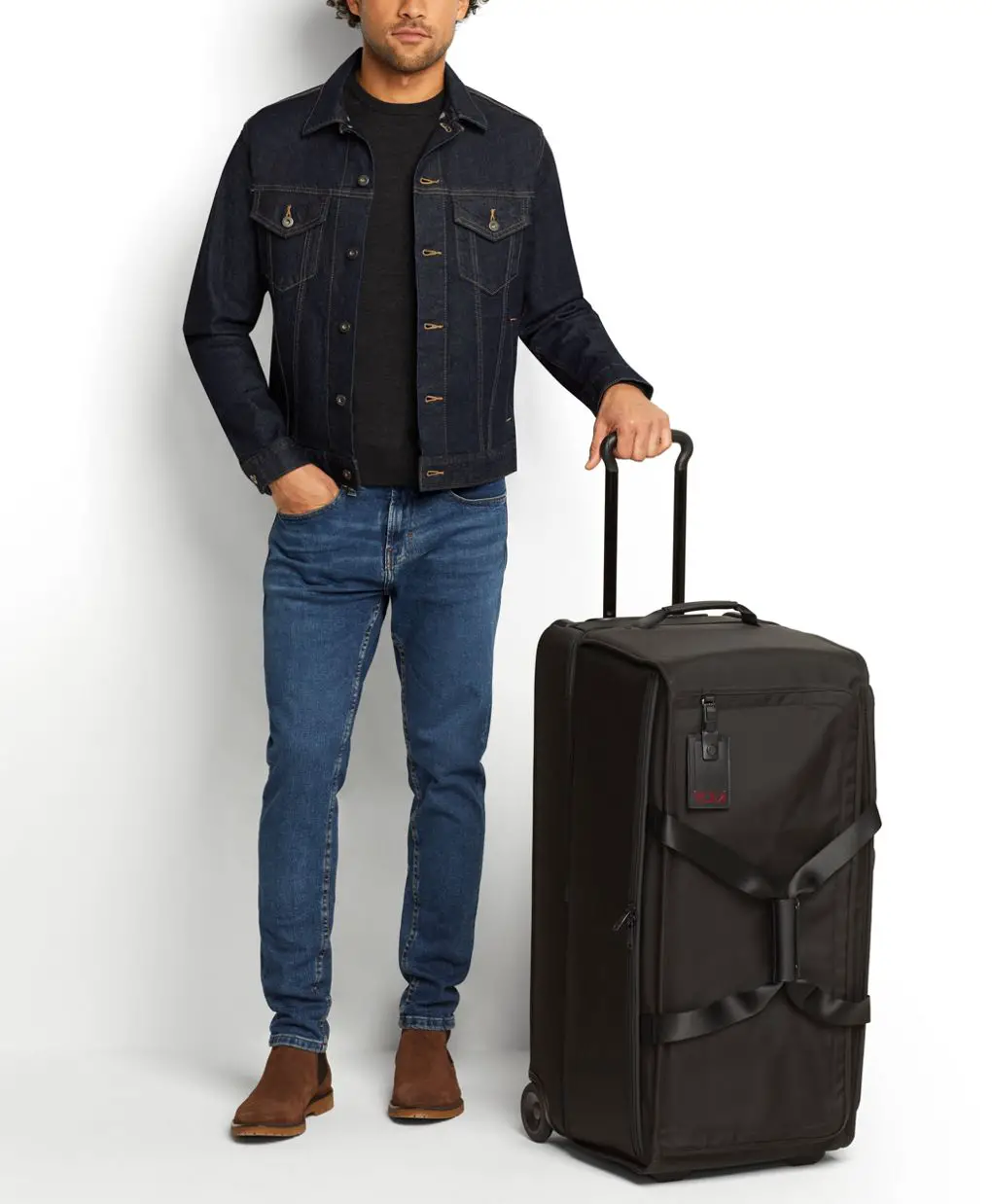 man standing with tumi large 2 wheeled duffel