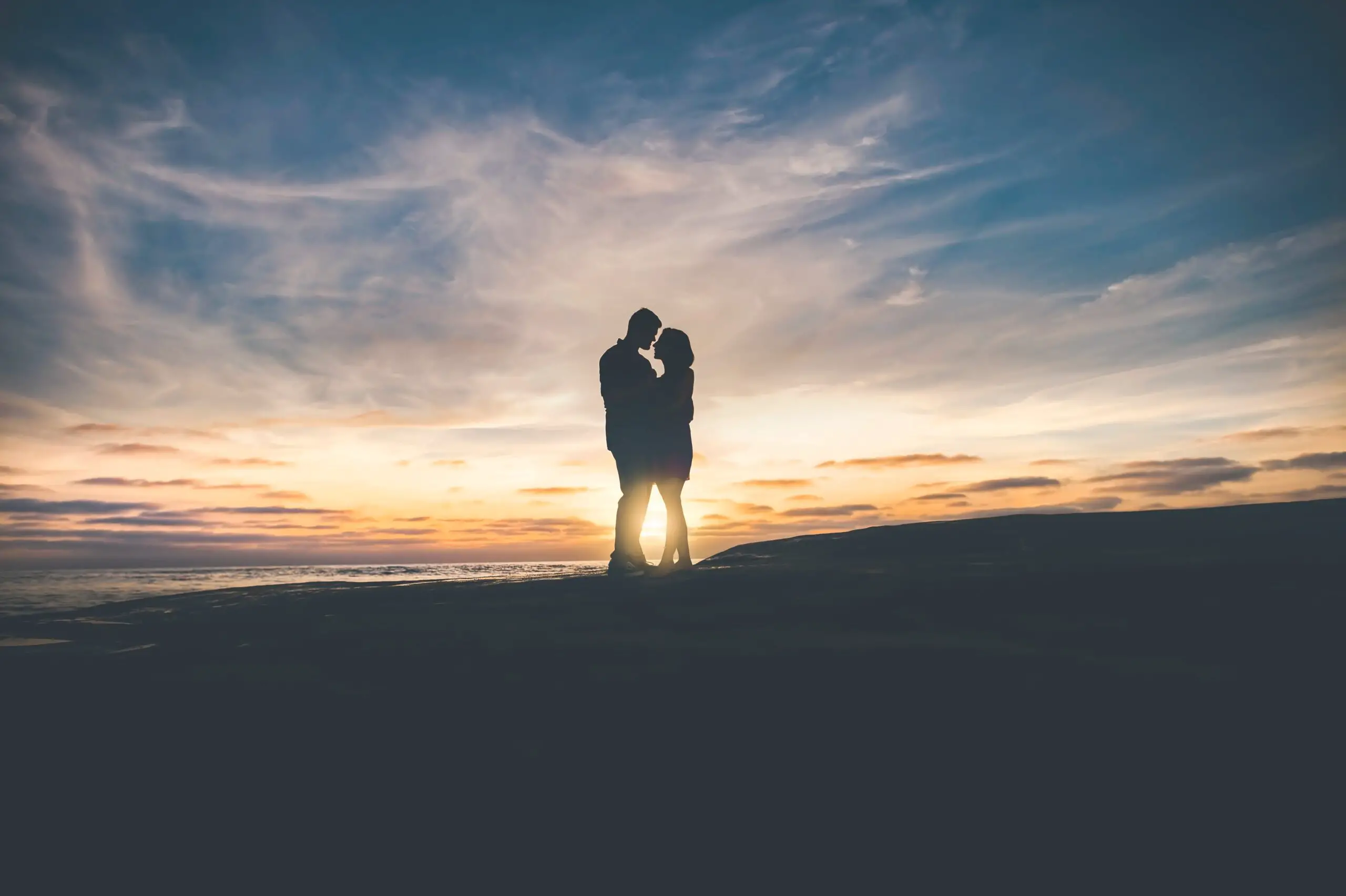 Couple traveling and posing at sunset
