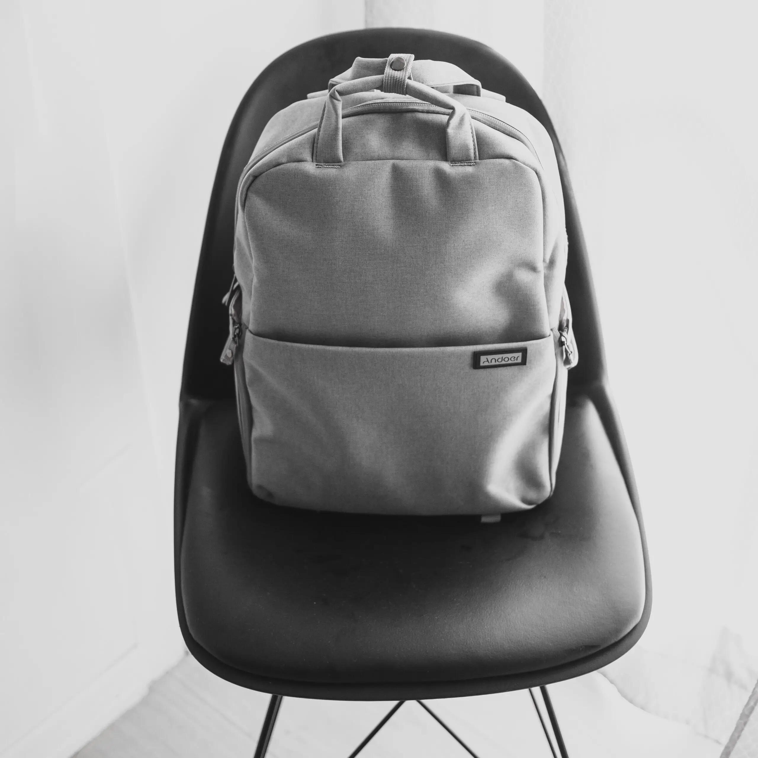 Minimalist backpack black and white on chair