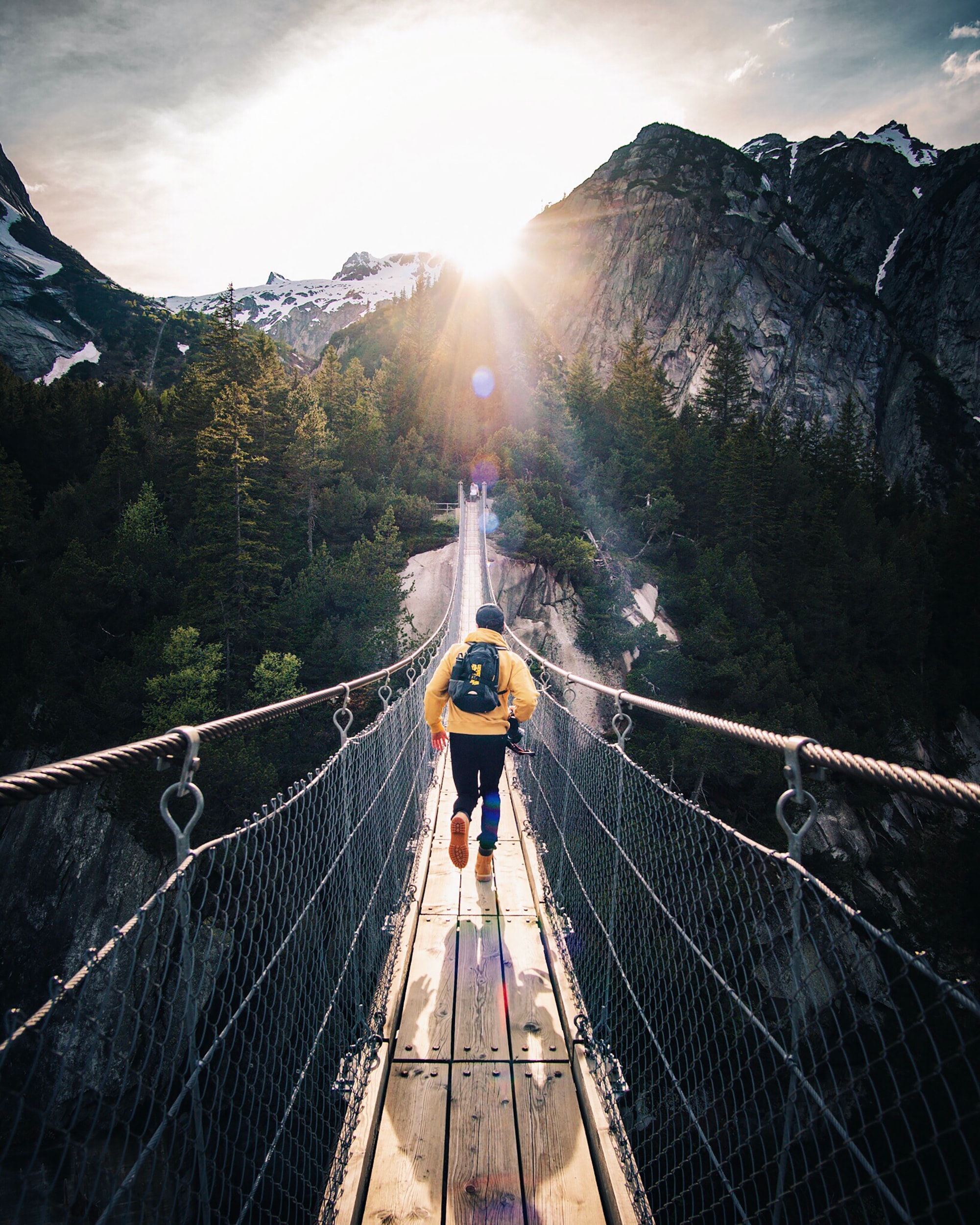 man running down bridge adventure