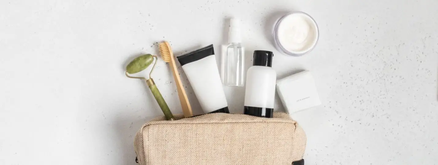 toiletry bag with objects laying on table