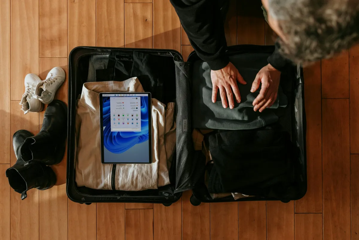 Person organizing and packing a suitcase with packing cubes