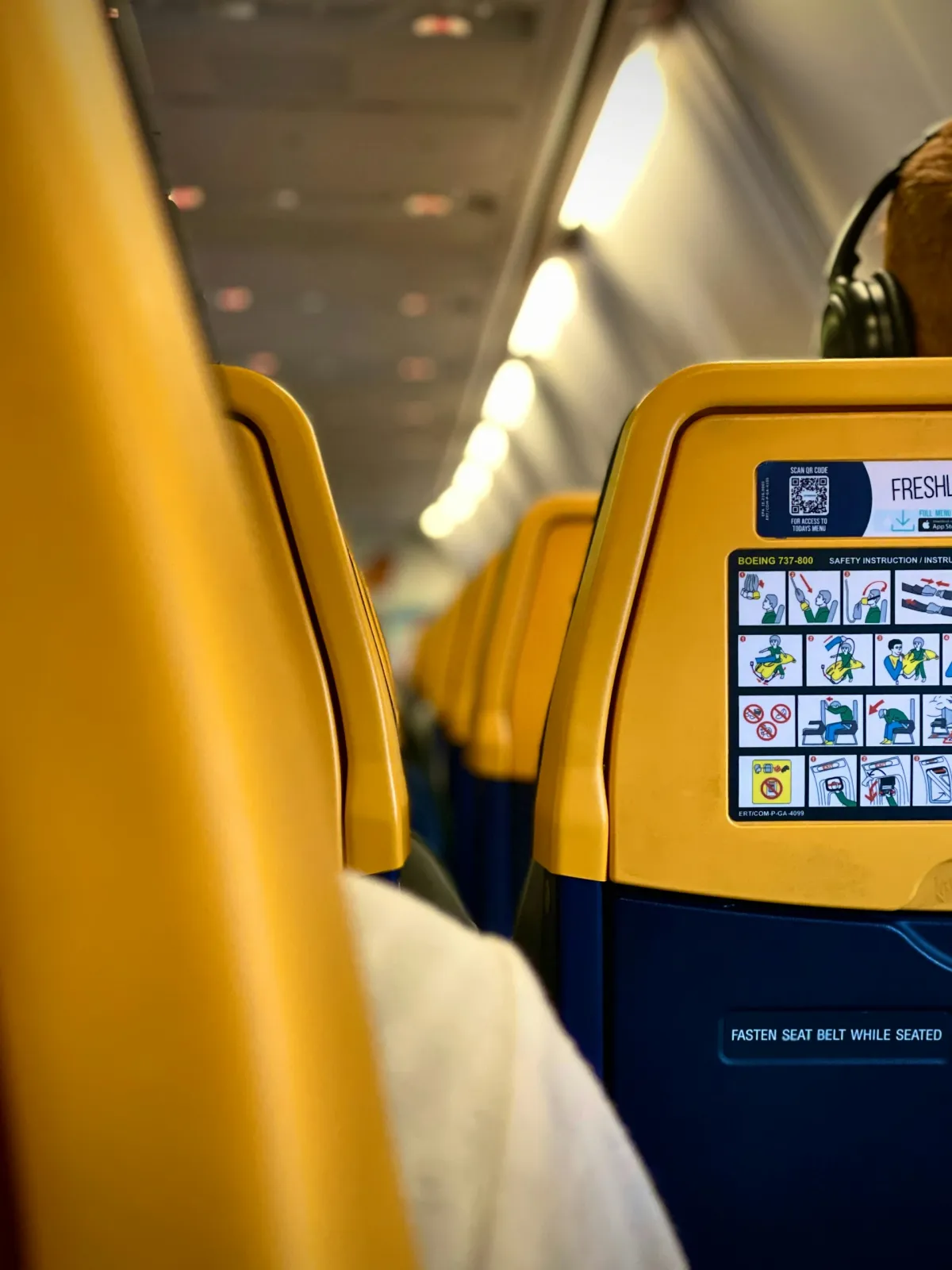 Airplane seat with headphones for Bluetooth travel guide