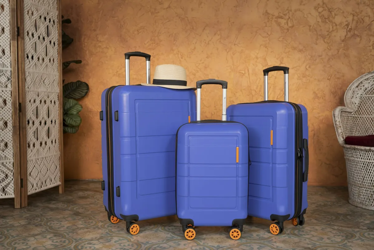 Three blue hardside suitcases for luggage material comparison
