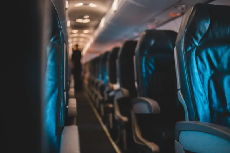 Close-up of black airplane seats showing premium material texture