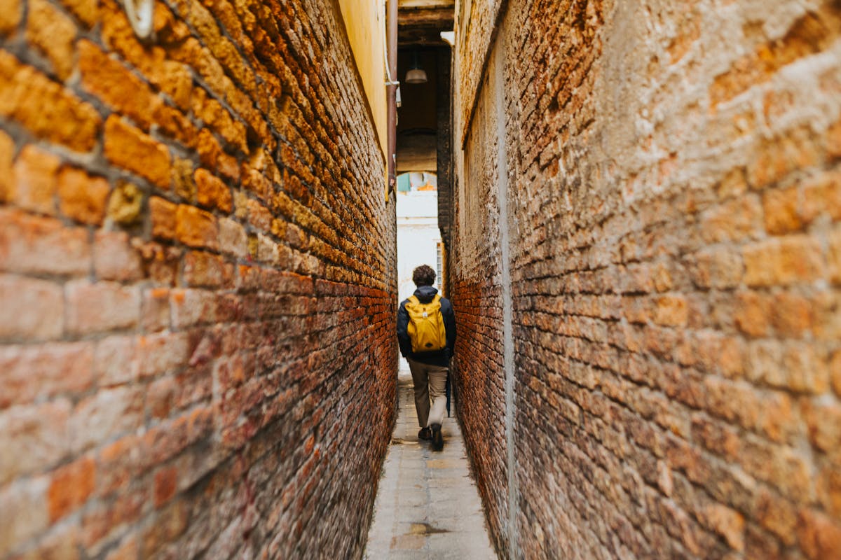 Urban traveler with backpack exploring a city street