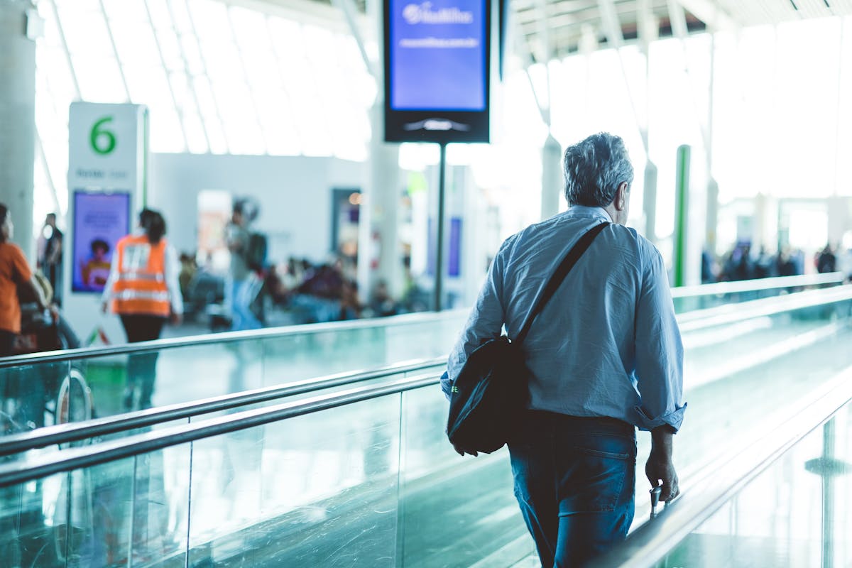 Traveler with small backpack in a modern airport terminal