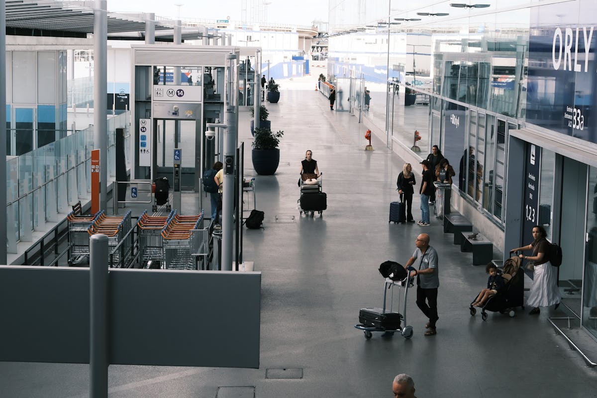 Busy airport terminal with travelers and their luggage