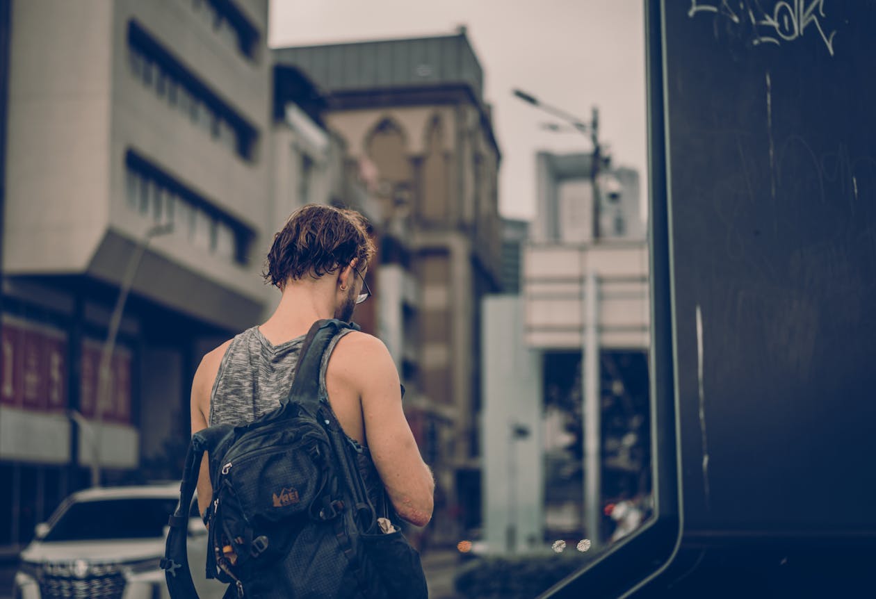Man with a sling bag exploring an urban city street