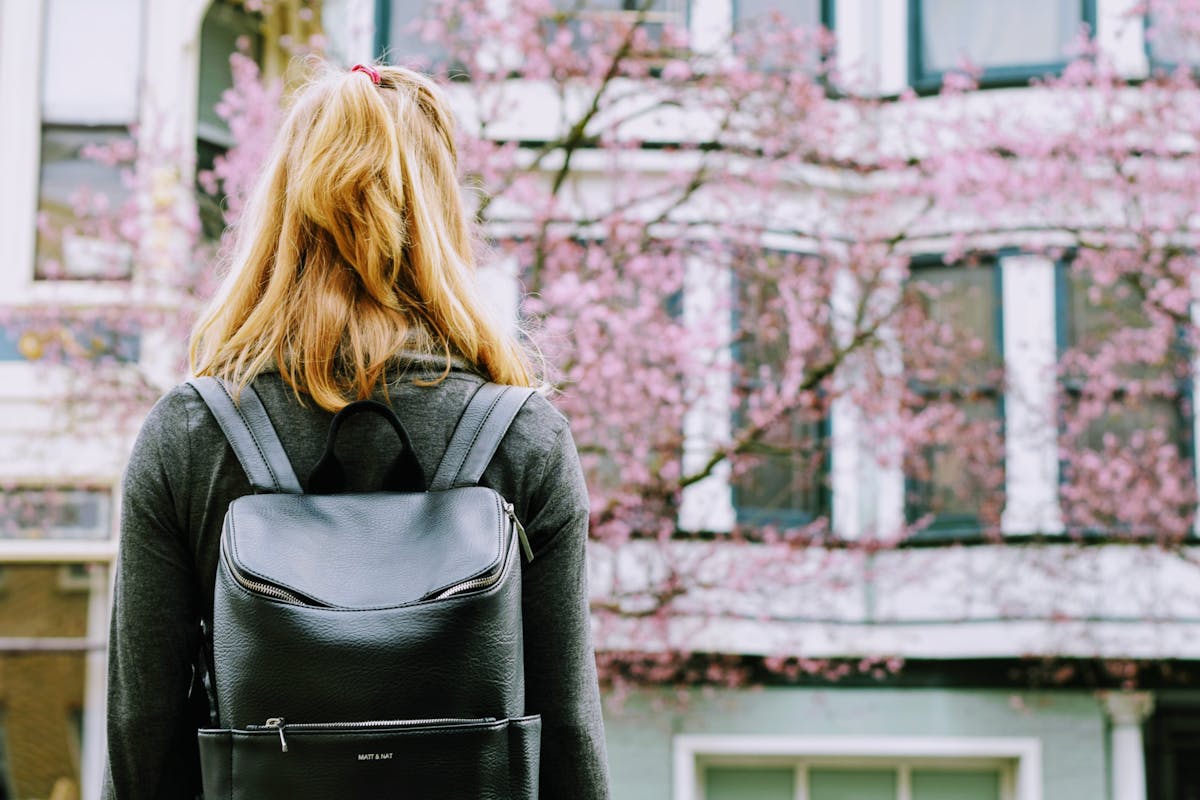 Traveler with mini backpack exploring a city