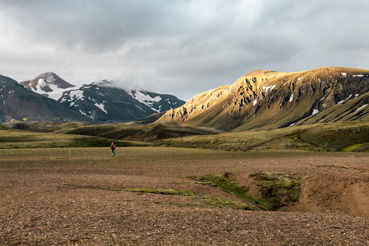 Hiker with a daypack on a mountain trail