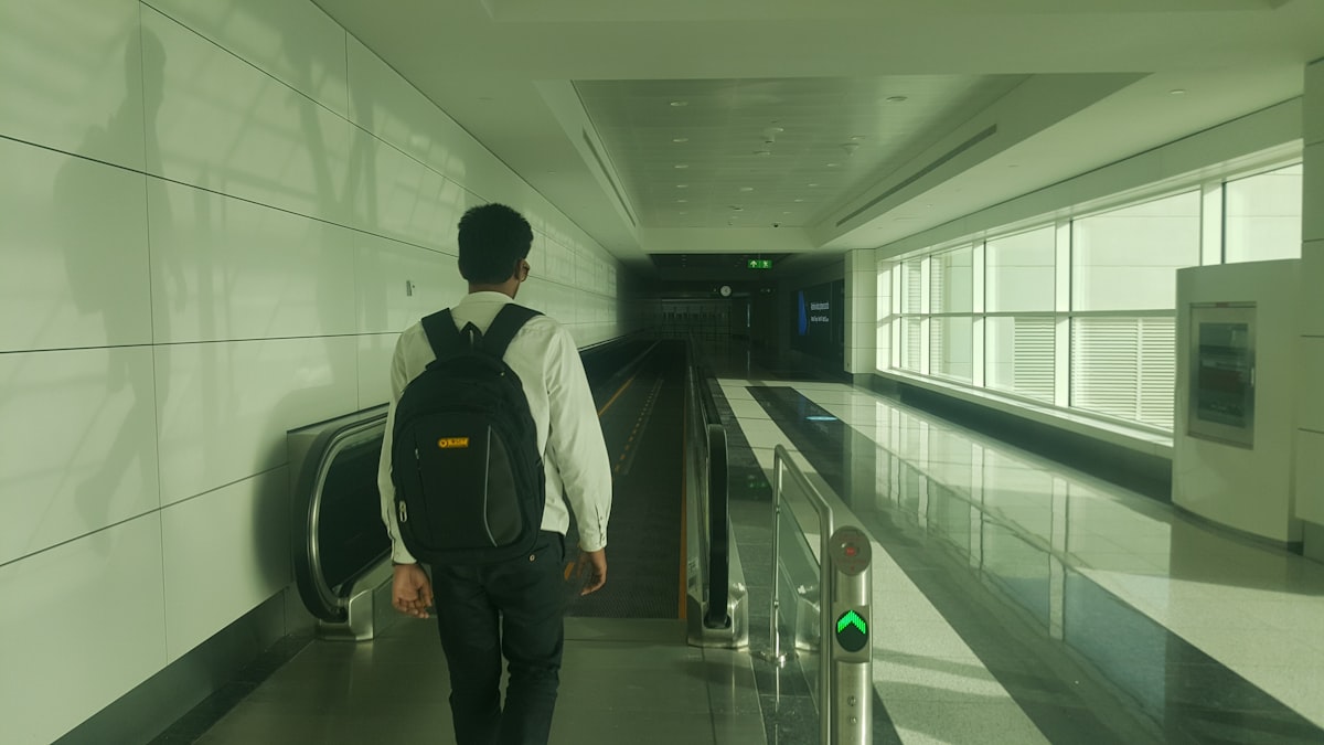 Man traveling with a backpack at an airport