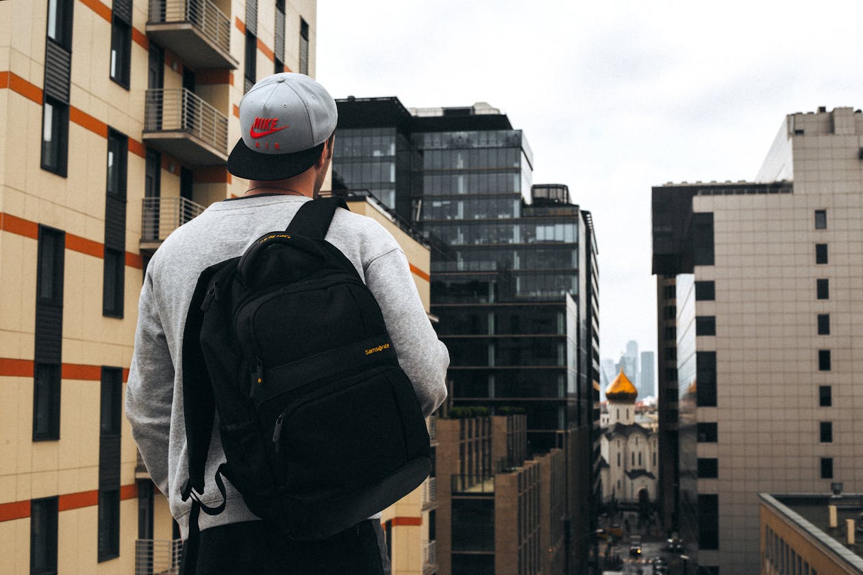 Man with a premium backpack standing on a modern city street