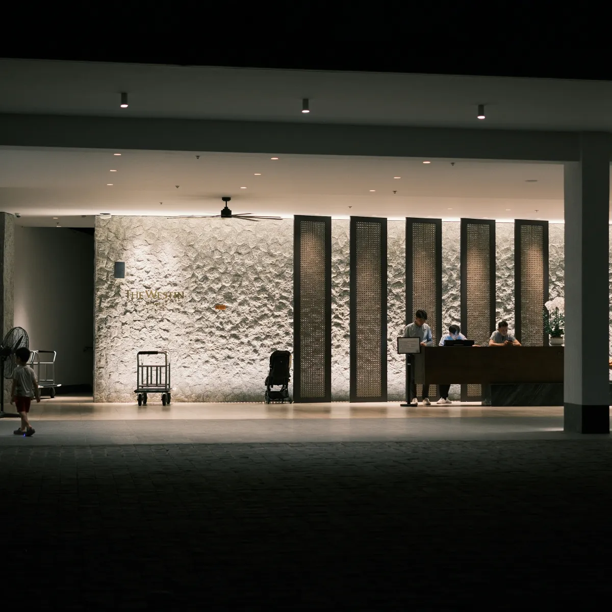 Hotel lobby with front desk staff ready to process late check-in arrivals