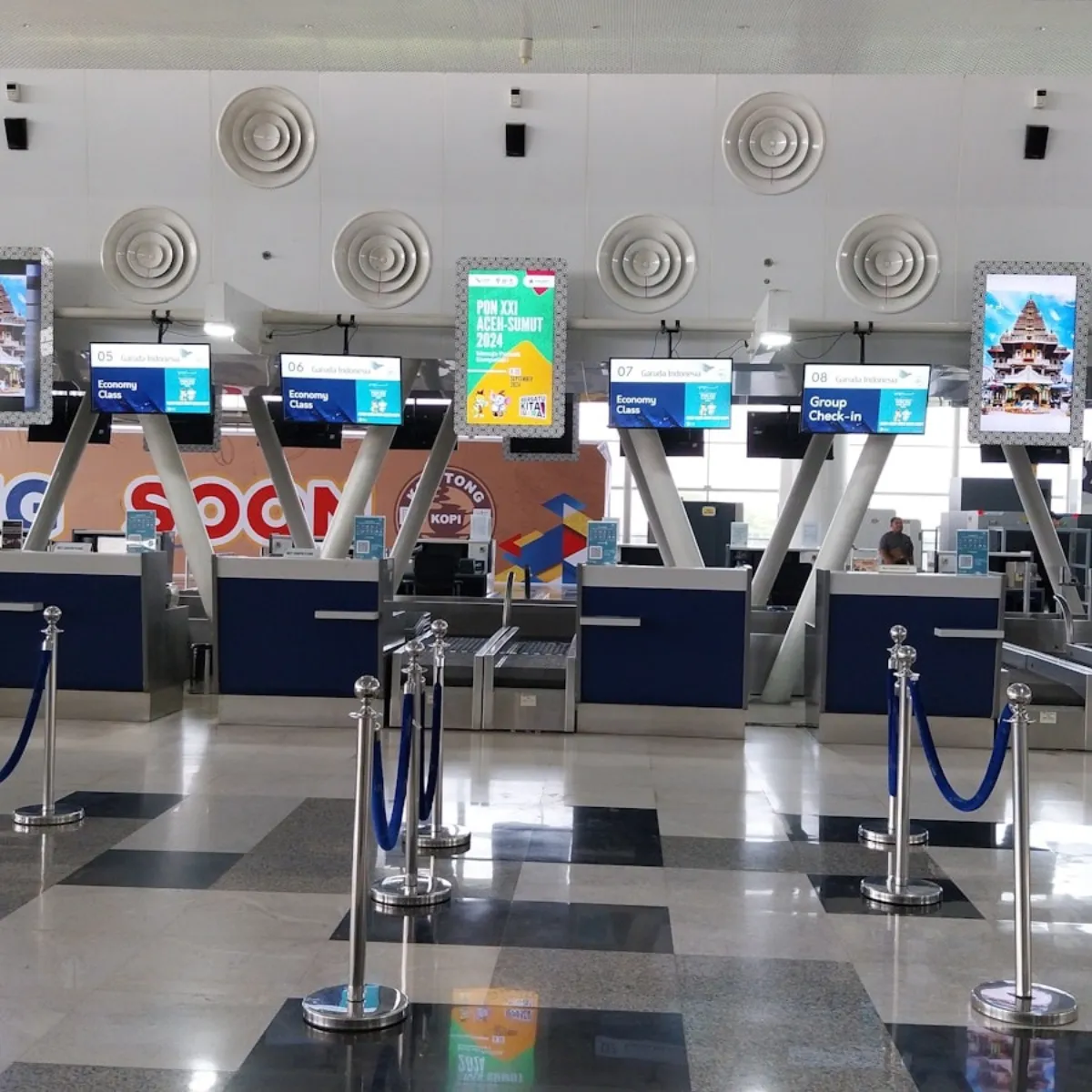 Busy airport check-in counters where suitcase dimensions are verified against airline rules