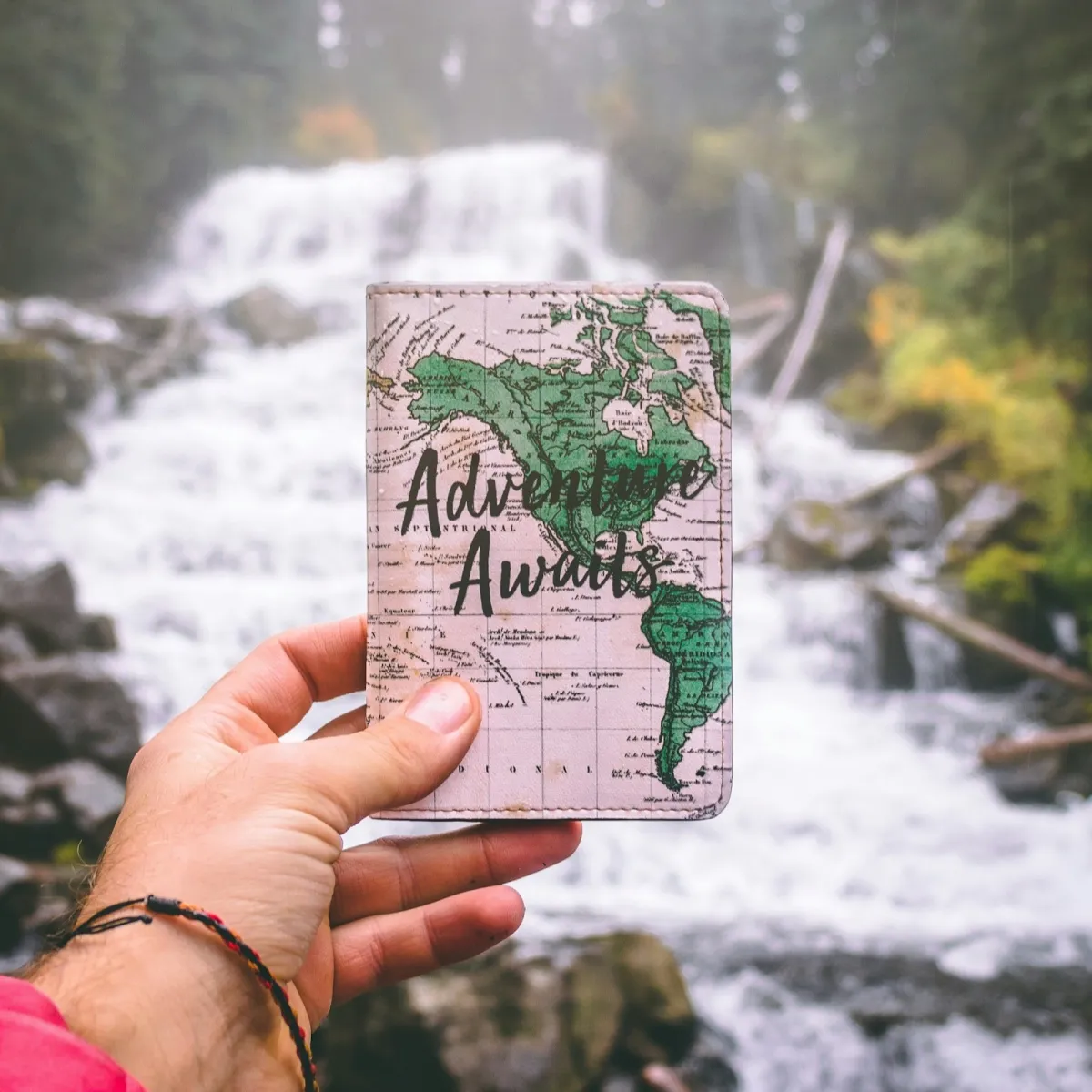 Leather passport holder photographed in selective focus against a muted travel backdrop.