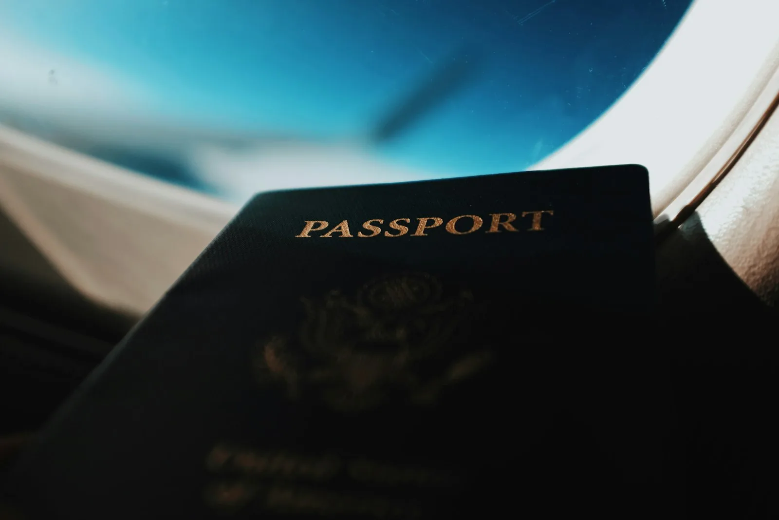 Silhouette of passport booklet with airplane window background