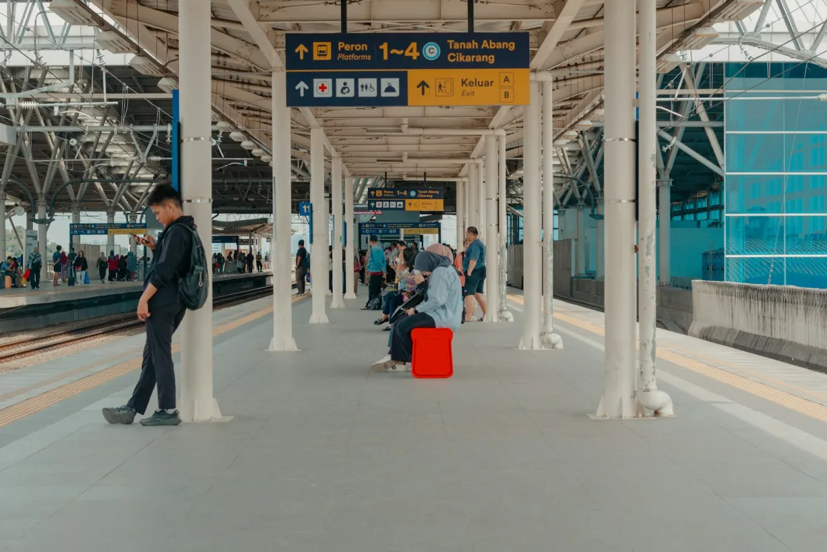 Commuters waiting under a covered station platform