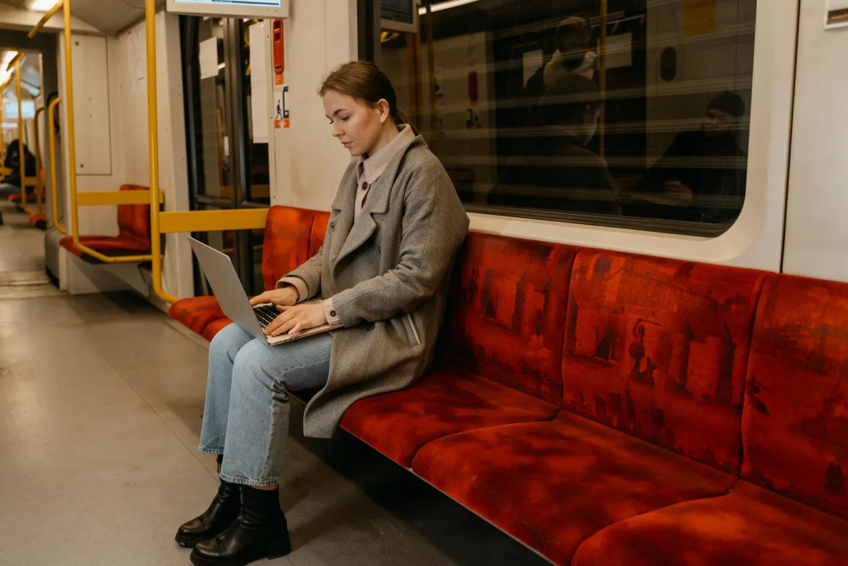Working on a laptop in a subway car during a commute