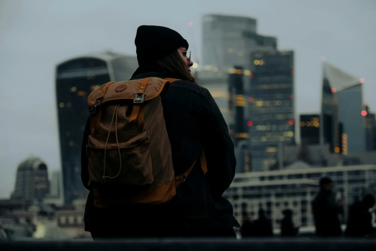 Commuter with a backpack looking out over the city