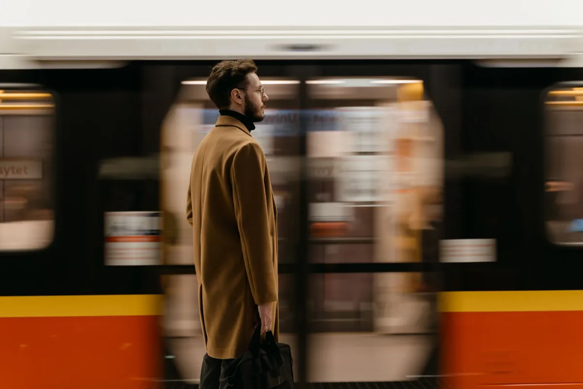 Commuter standing on a platform as a train passes