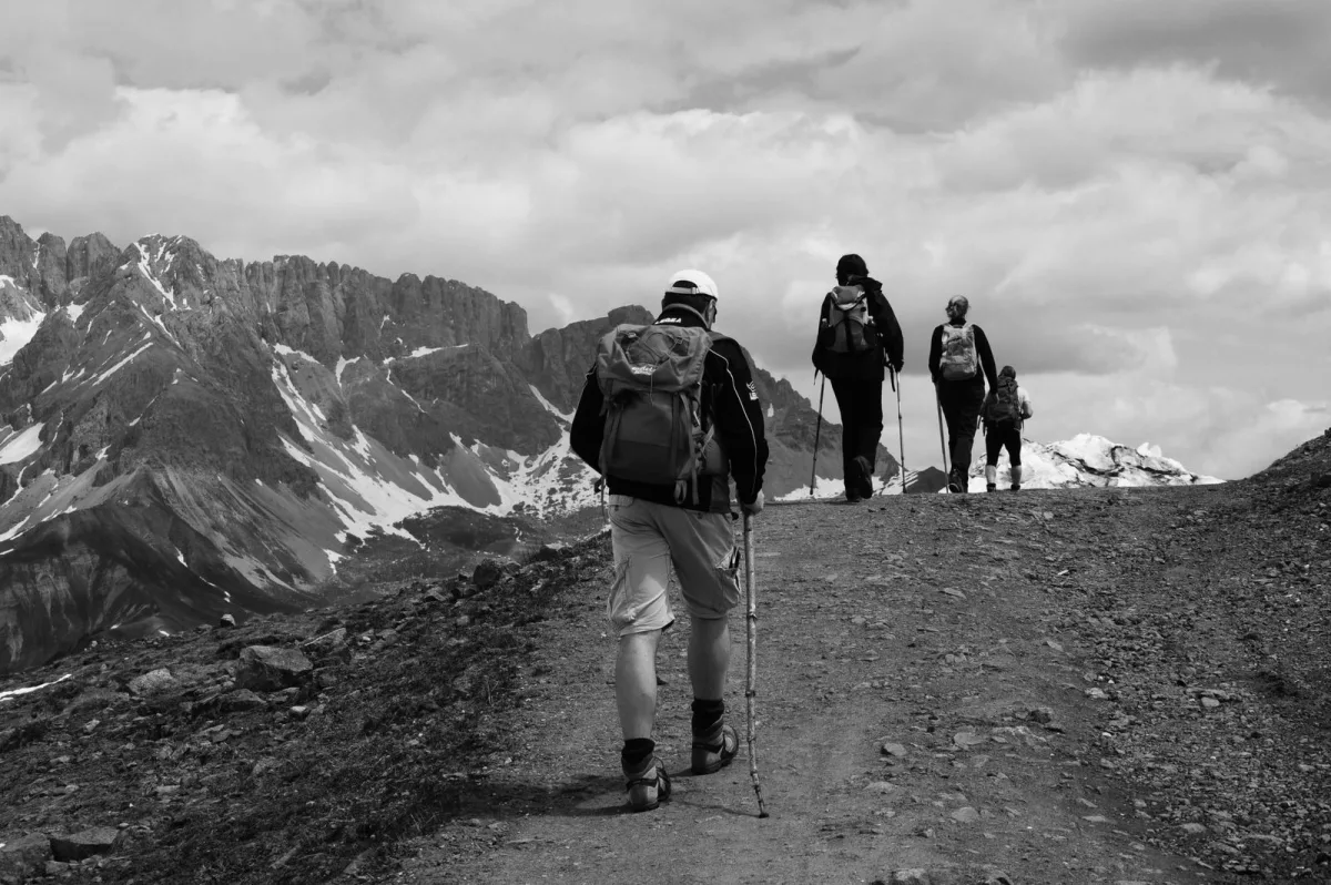 Group of walkers crossing high mountain terrain with packs