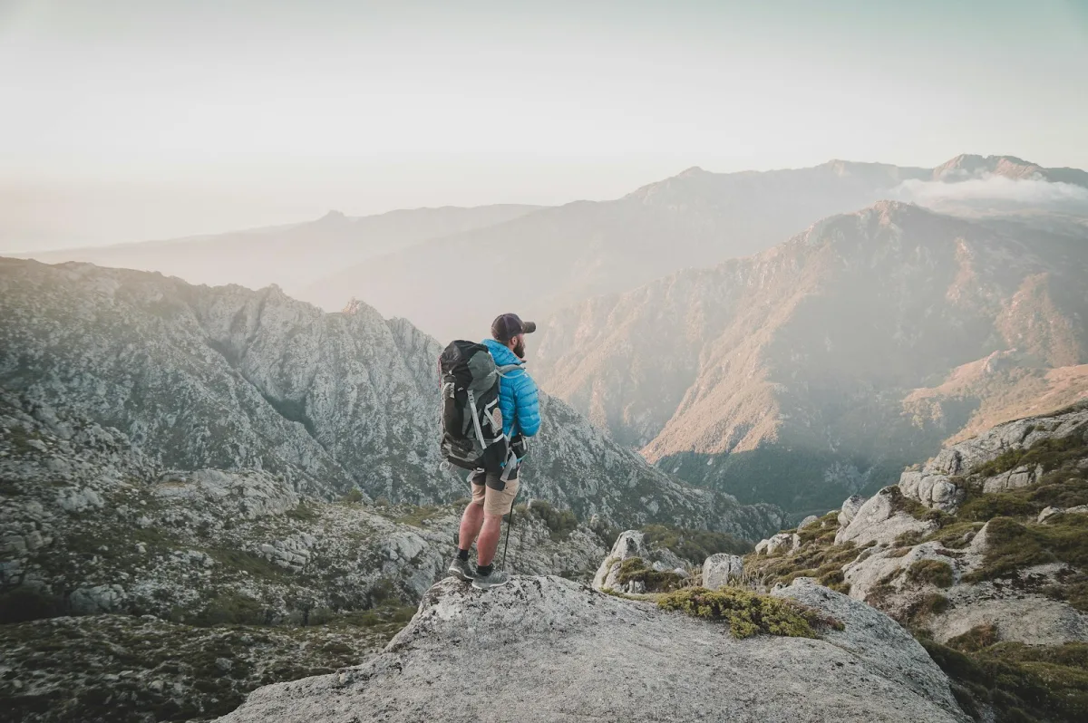 Hiker with a large pack on a rocky mountain route