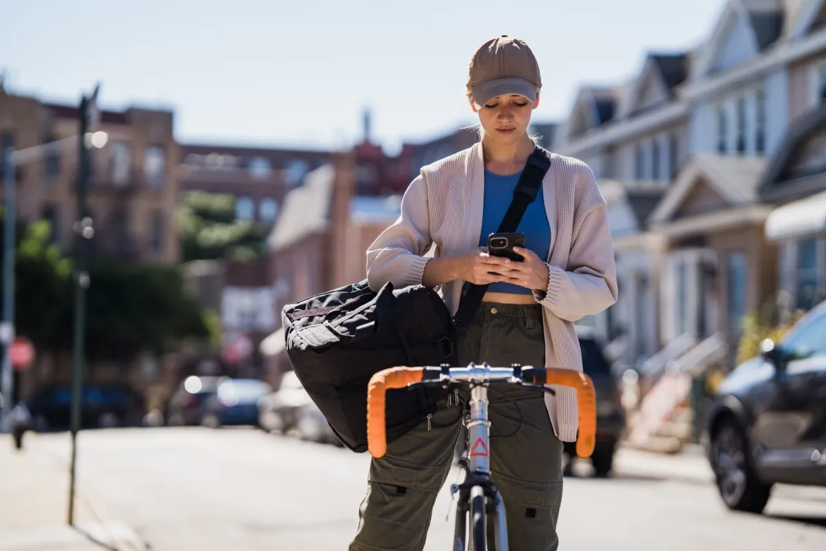 Cyclist in the city wearing a sport bag across the body