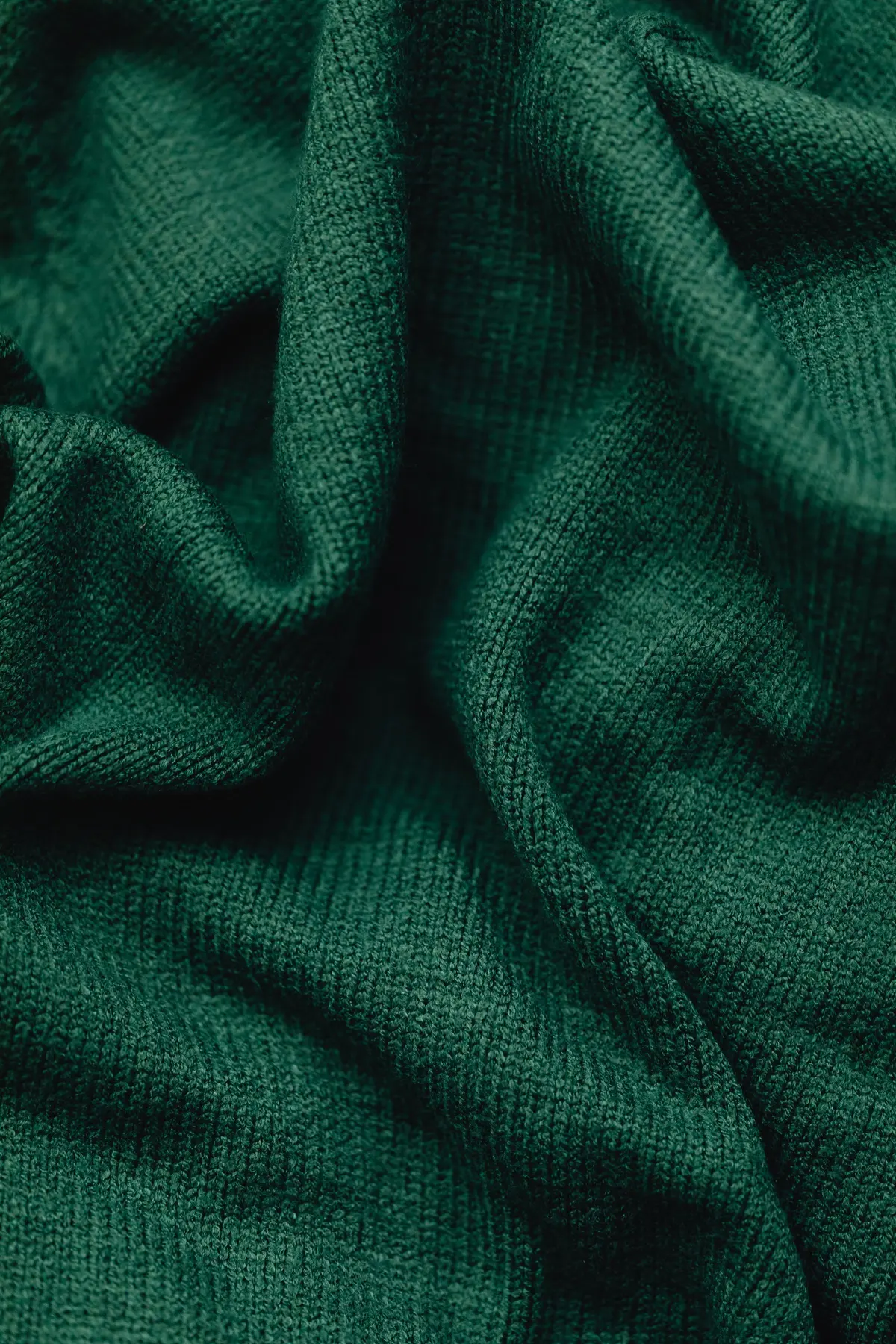 Dark green fabric draped in soft folds